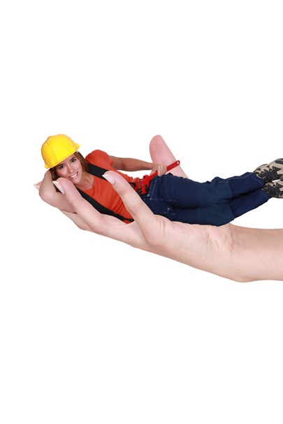 Female laborer laid in giant hand - Photo, Image