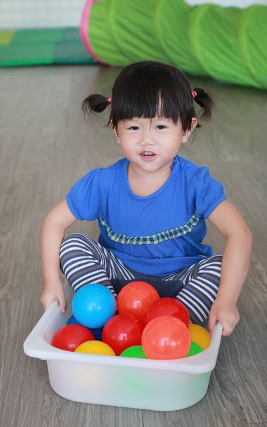 Asian Child playing colorful balls in plastic tray at the kid room - Foto, Imagem