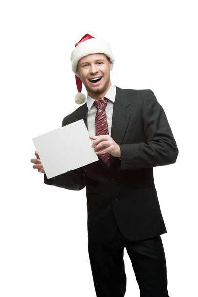 Businessman in santa hat holding sign - 写真・画像