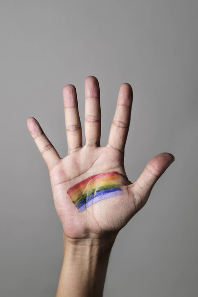 man with a rainbow flag in his hand - Photo, image