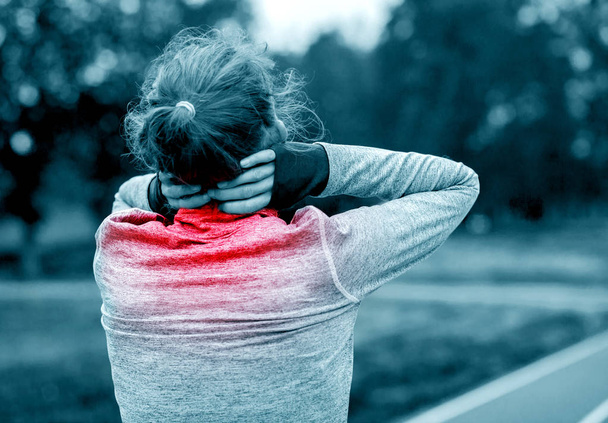 Athletic woman on running track touching hurt neck with painful  - Valokuva, kuva