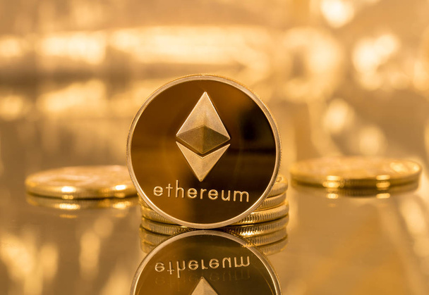 Stack of ethereum coins with gold background - Photo, Image
