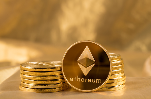 Stack of ethereum coins with gold background - Photo, Image