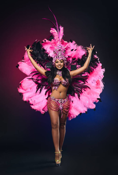 Cute young girl in bright colorful carnival costume on dark back - Fotoğraf, Görsel