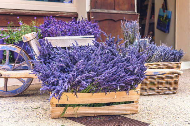 Lavender for sale close-up.Assembled lavender on sale in wooden boxes and a basket.A lot of lavender on sale. - Фото, изображение