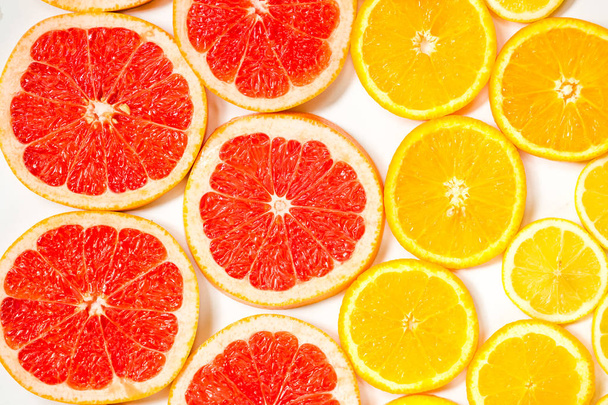 Gradient color citrus slices on white background - Foto, Imagen