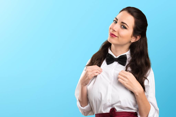 Young beautiful waitress proud of herself on colorful background - Фото, изображение