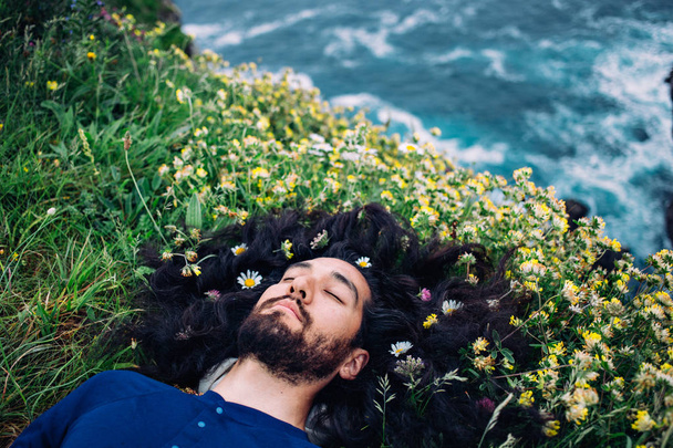 bearded man with flowers in hair - Foto, imagen