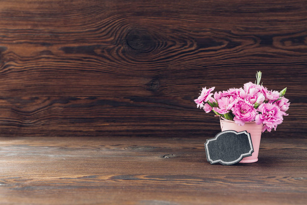 bouquet of pink Carnation flowers in vase on wood background. Empty space for text - Fotoğraf, Görsel
