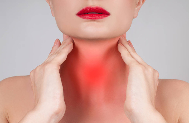 Young woman has sore throat touching the neck - Foto, Imagem