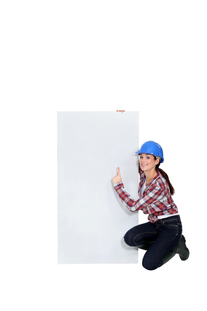 Female worker pointing to advertising - 写真・画像