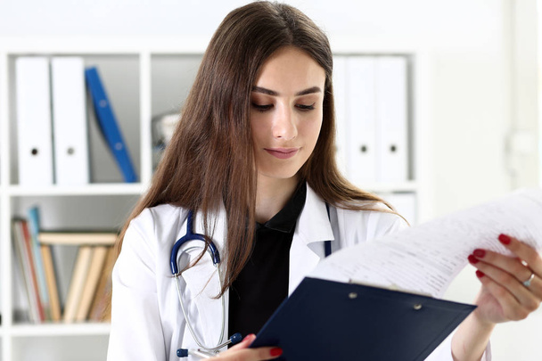 Beautiful smiling female doctor hold clipboard pad - 写真・画像