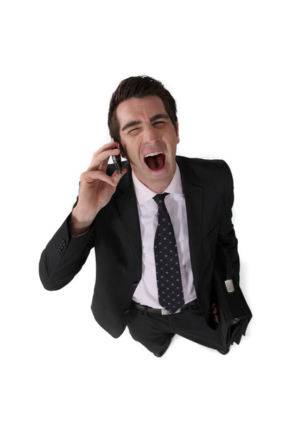 Businessman screaming down the telephone - Foto, Bild