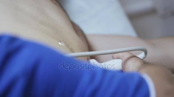 Close-up of doctor hand doing medical ultrasound male patient. - Filmagem, Vídeo