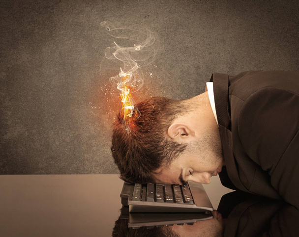 Sad business person's head catching fire - Photo, image