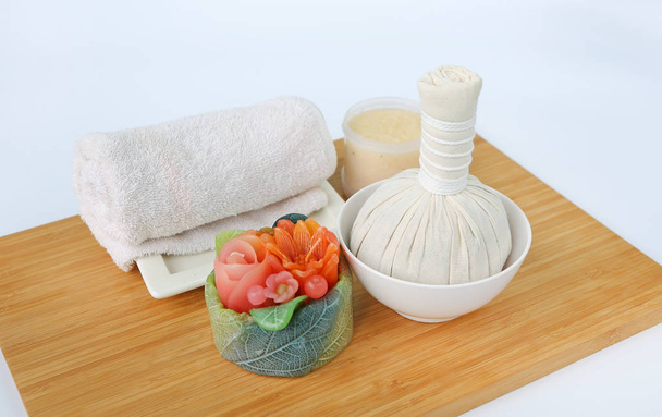 Spa herbal compressing ball with towels and Salt Scrub, Spa concept on bamboo board against white background - Foto, afbeelding
