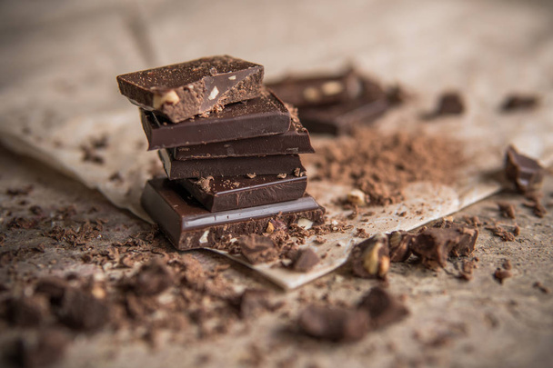 Dark chocolate stack with hazelnuts, selective focus - Photo, Image