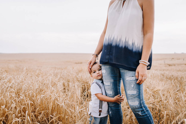 mother and son walking in wheat field - Zdjęcie, obraz