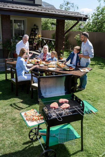 Happy family at barbecue  - Фото, зображення