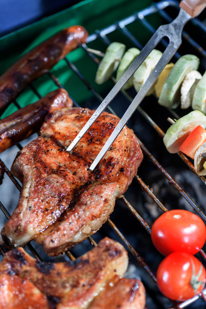 meat pricked by carving fork on grill - Photo, Image