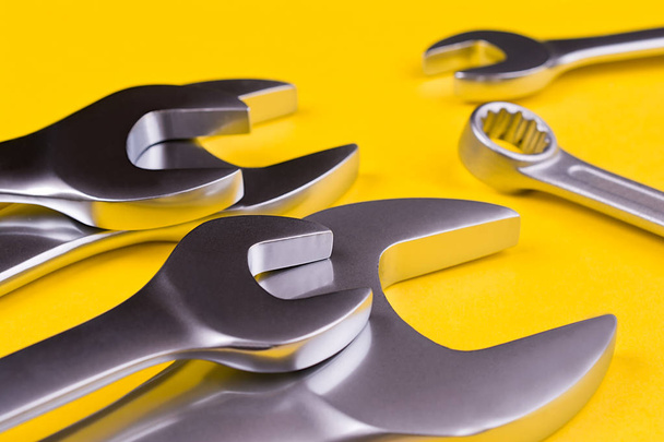 Spanners of various sizes, on yellow background. - Photo, Image
