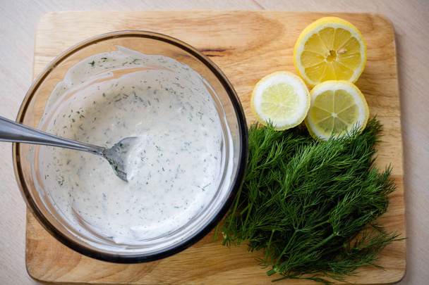Dill sprigs and chopped lemon ingredients - Photo, Image