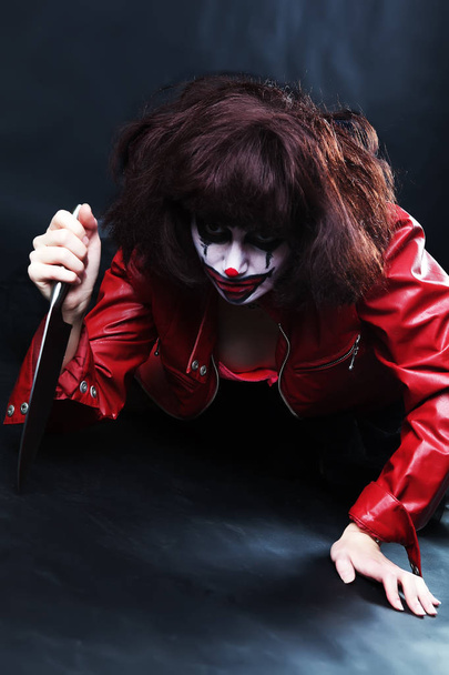 model with makeup scary clown with knife - Photo, image