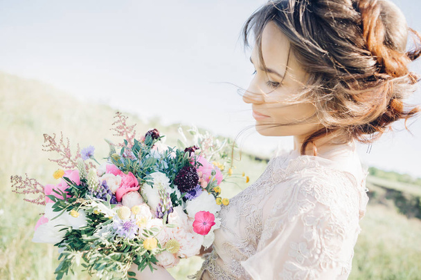 Portrait of beautiful bride with bouquet in nature. fine art photography. - Fotó, kép