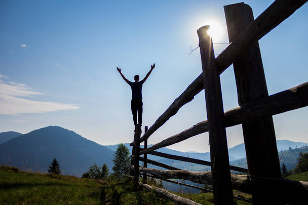 Man with hands up on top of mountains - Photo, Image