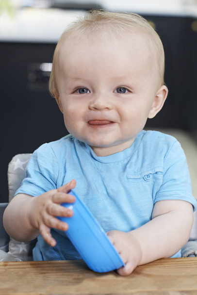 Happy Toddler With Empty Bowl Sitting At Table  - Photo, Image