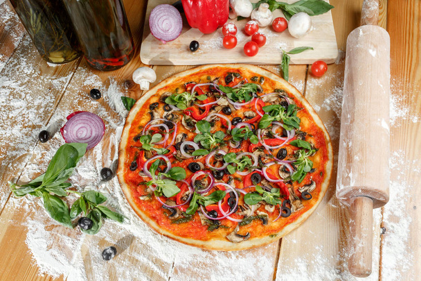 Baked pizza with mushrooms and paprika and ingredients. Italian traditional food - Photo, Image