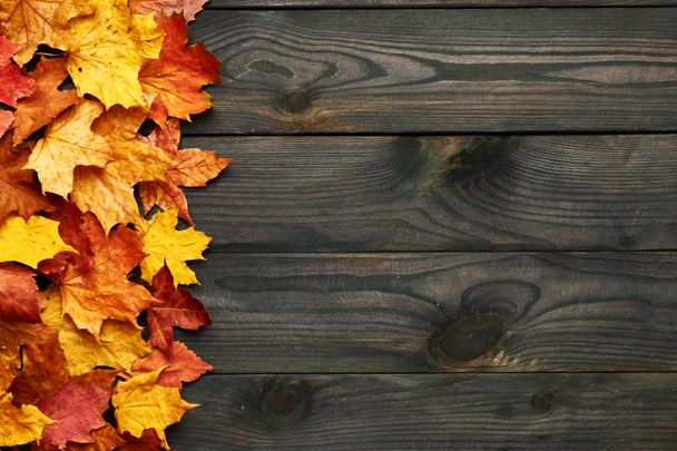 Wooden planks with autumn leaves  - Photo, Image