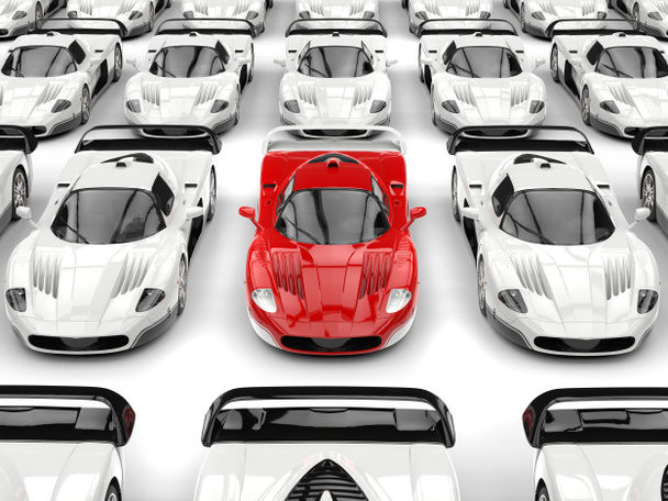Upea punainen moderni konsepti urheiluauto erottuu valkoisten urheiluautojen meressä.
 - Valokuva, kuva