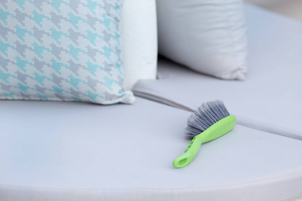 Cleaning brush on outdoor furniture - Foto, Imagen