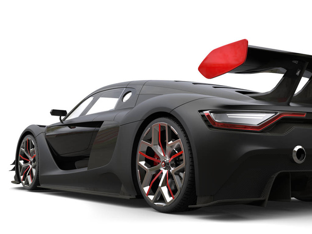 Gorgeous matte black super car with red details on the wheels and rear wing - Photo, Image