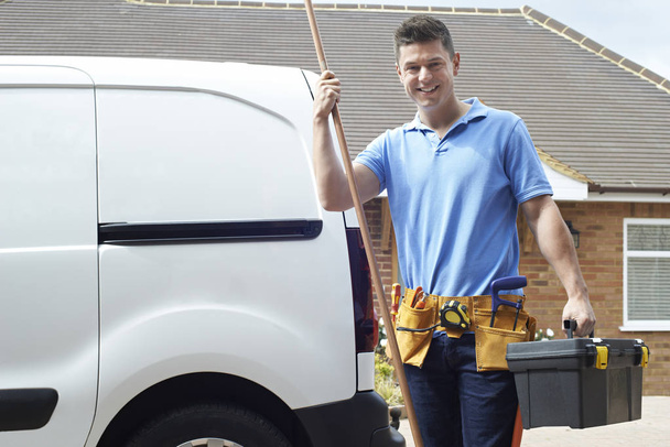 Plumber With Van Talking On Mobile Phone Outside House - Photo, image