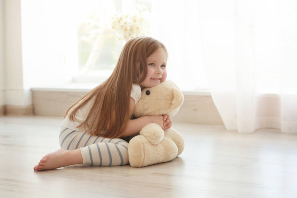 Cute little girl  with teddy bear   - Фото, изображение