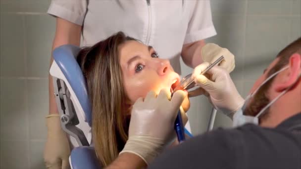 Zapewnia czyszczenie dla pacjenta kobieta zębów dentysta - Materiał filmowy, wideo