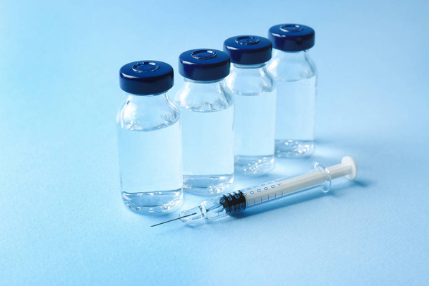 Vaccine in vials with syringe   - Foto, afbeelding