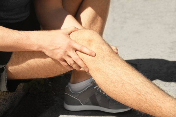man suffering from pain in leg - Фото, изображение