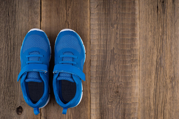 Blue Sneakers with wooden background.  - Fotografie, Obrázek