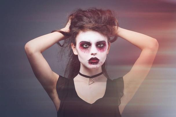 Young woman with Halloween makeup on color background - Фото, зображення