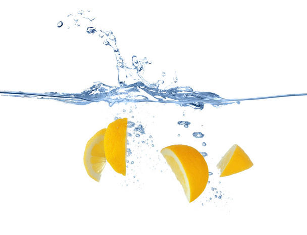 slices of lemon splashing in water  - Фото, зображення
