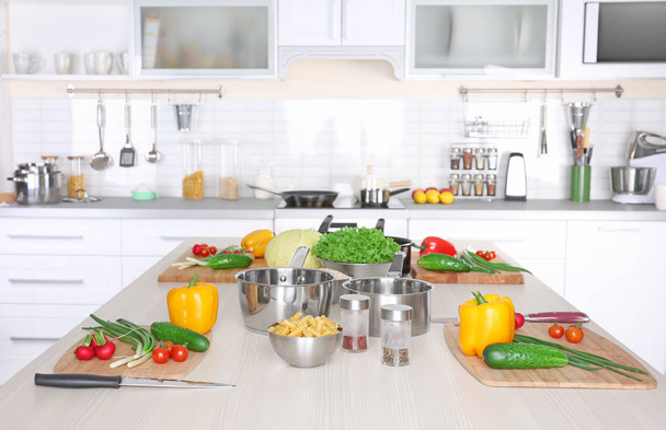 Fresh vegetables and utensils for cooking classes on wooden table - Valokuva, kuva