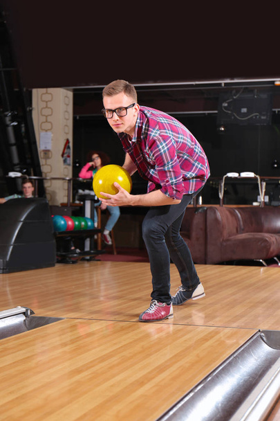 Young man having fun and playing bowling - Foto, Imagen