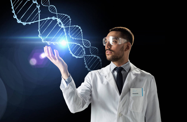 scientist in lab coat and safety glasses with dna - Foto, Bild
