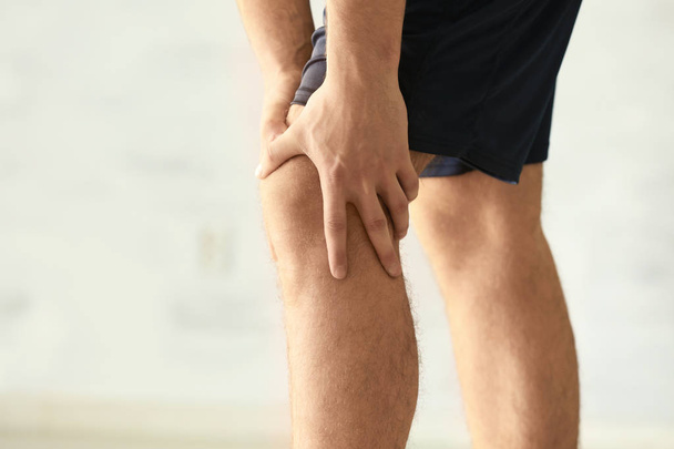 man suffering from pain in leg - Фото, зображення
