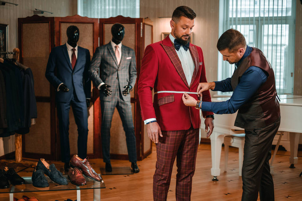 Tailor measuring client for custom made suit tailoring. - Photo, Image