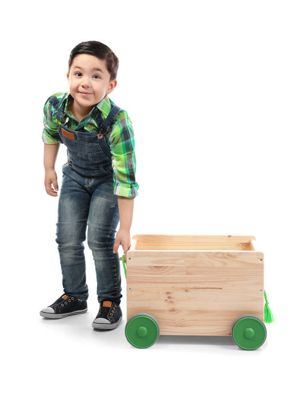 Cute little boy with wooden cart on white background - Foto, Imagen