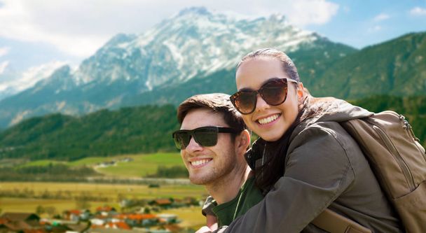 happy couple with backpacks traveling in highlands - Foto, imagen